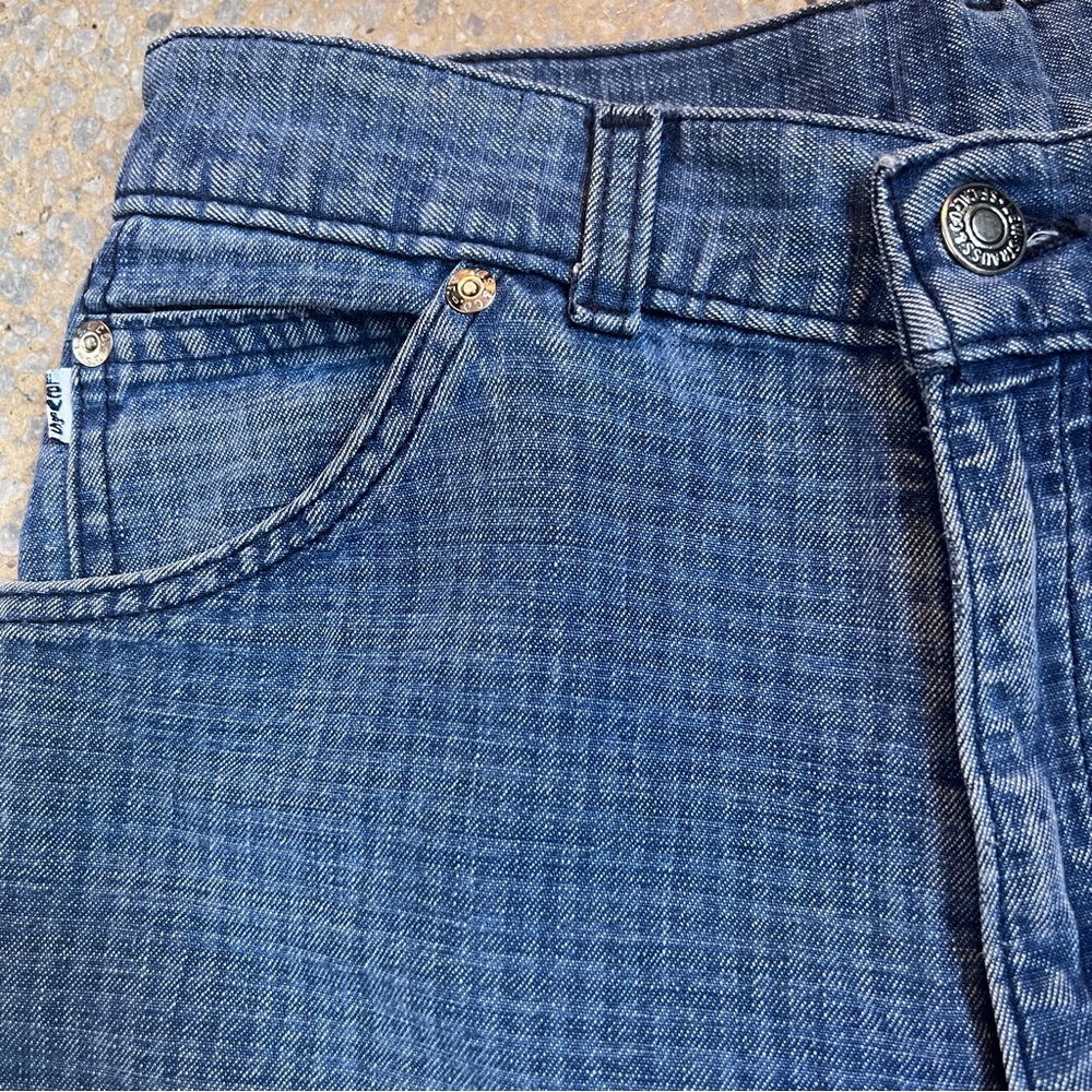 Vintage well worn and slightly tattered checkered Levi’s jeans. Size 28”